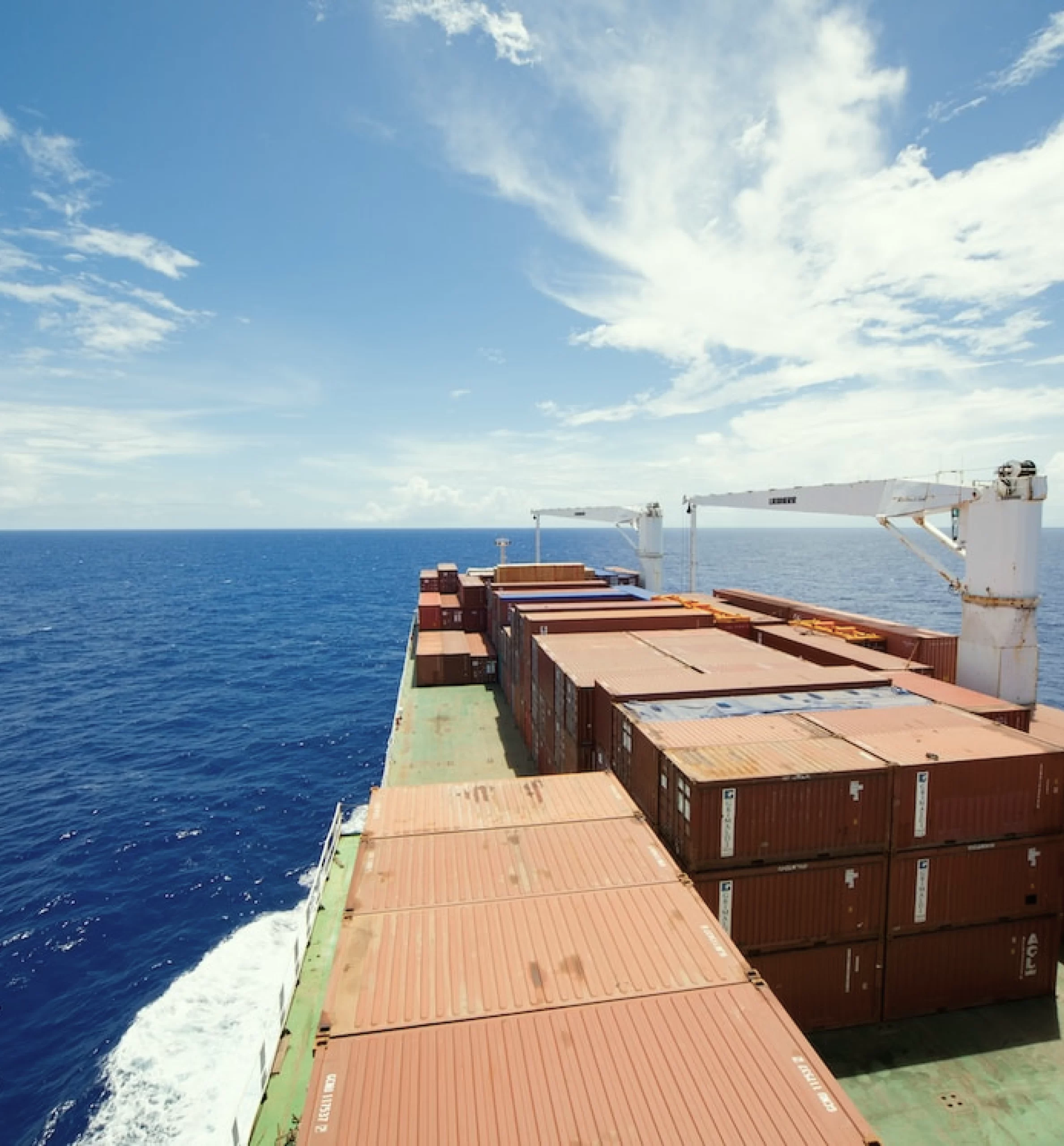 A large container ship sailing in the ocean, carrying essential goods worldwide.