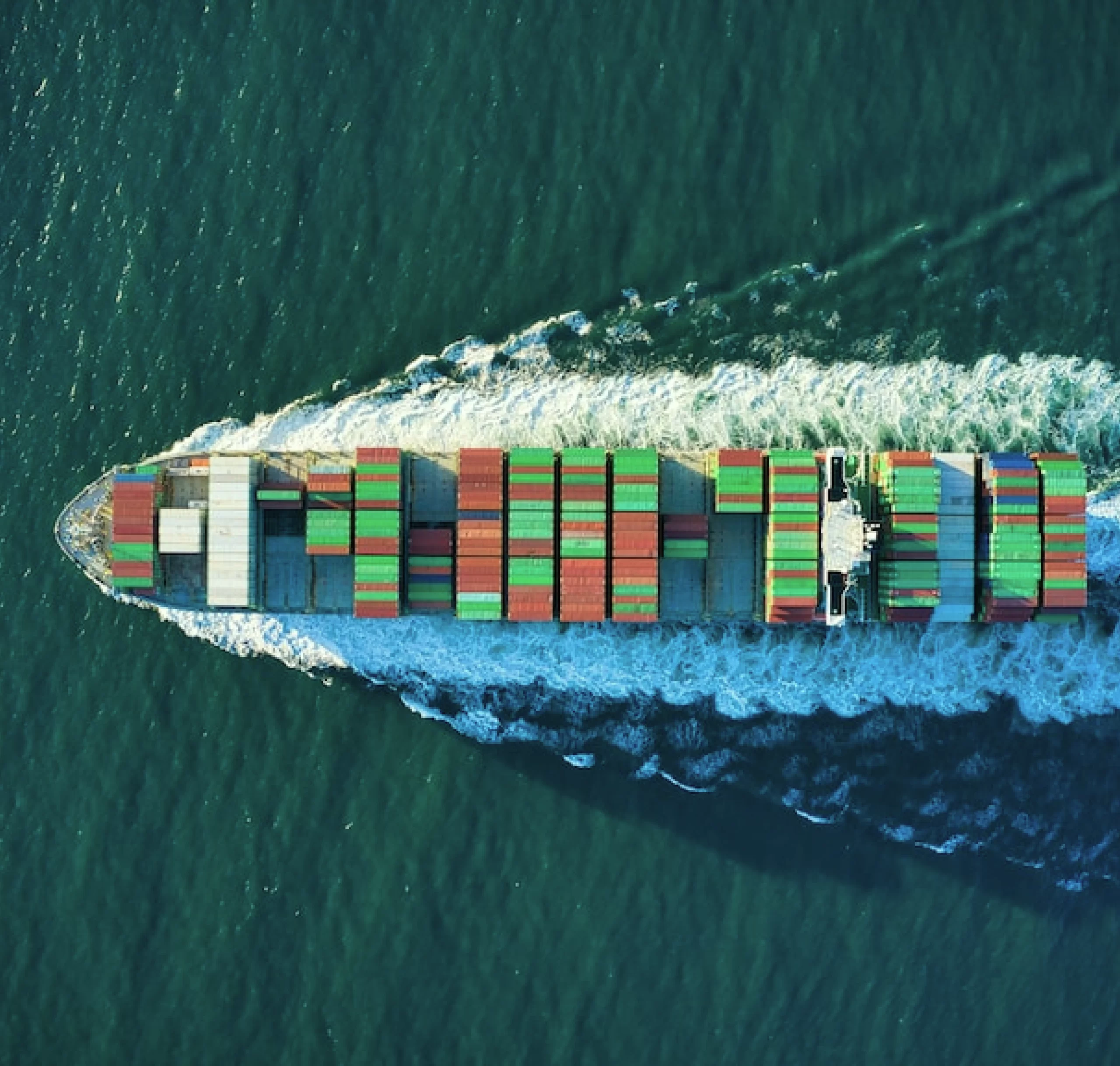 Company delivering aerial views of container ships in the ocean.
