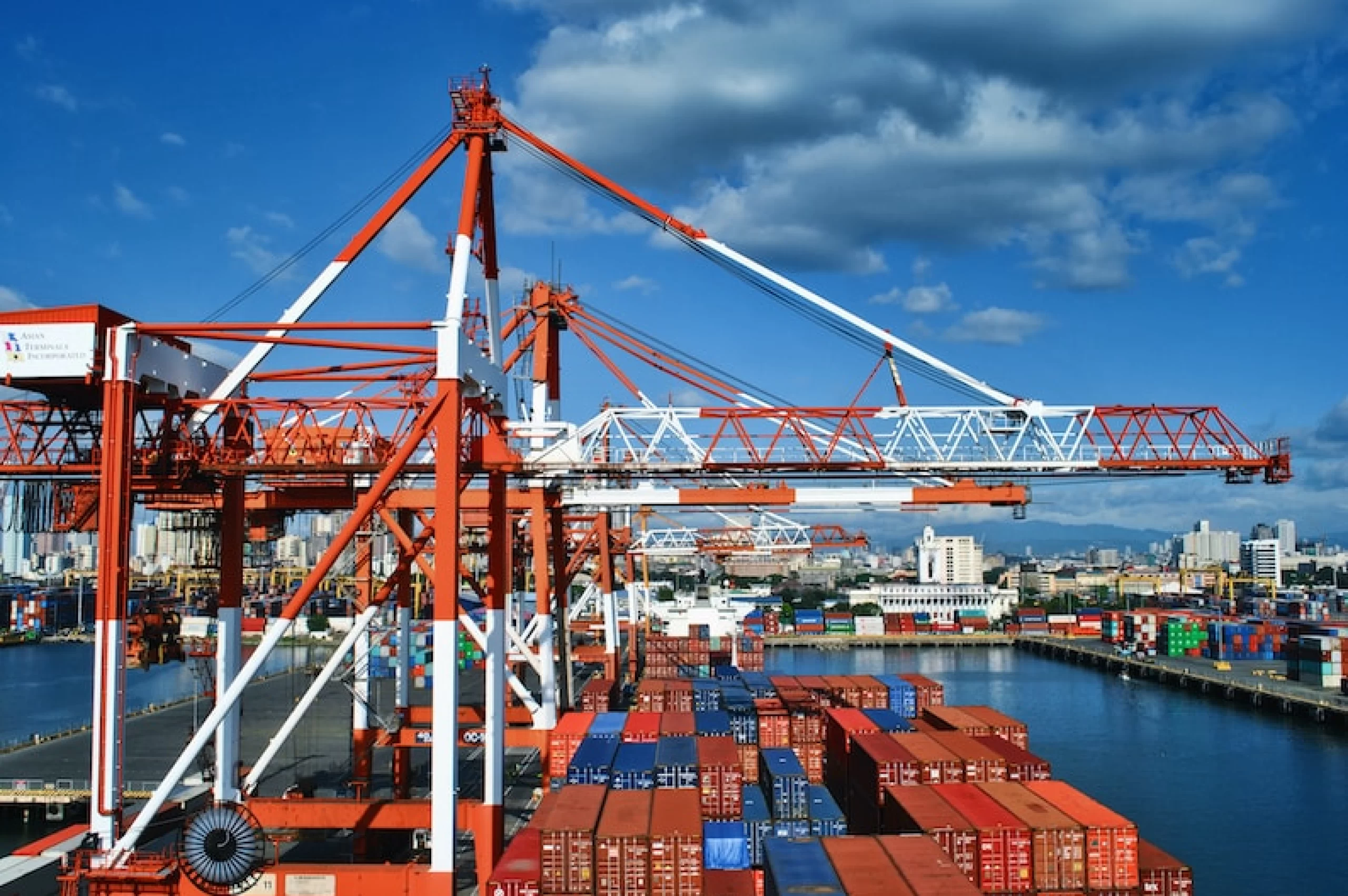 A container ship docked at a port, showcasing our maritime expertise.