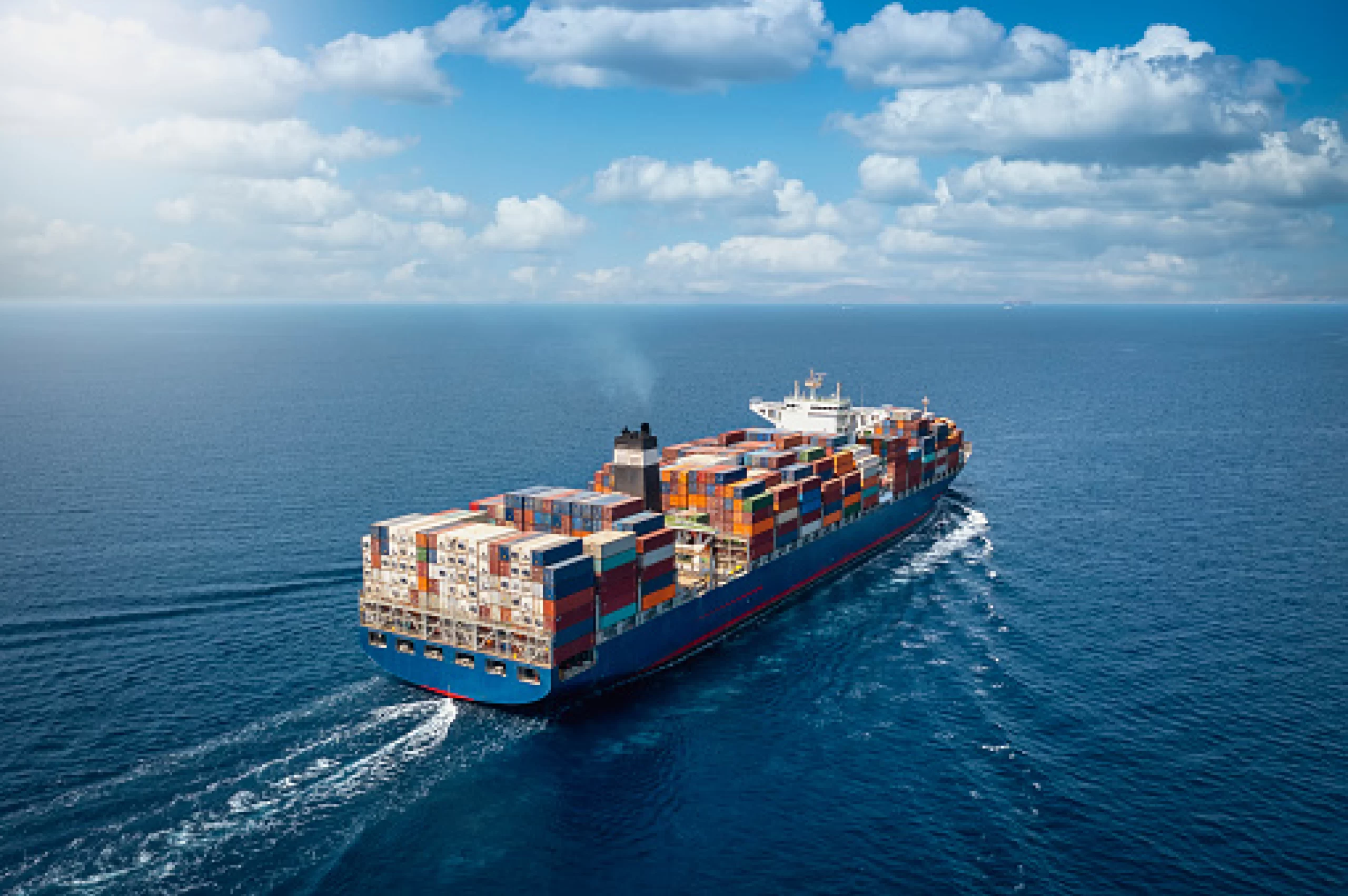 An aerial view of a top freight forwarder's large container ship in the ocean.
