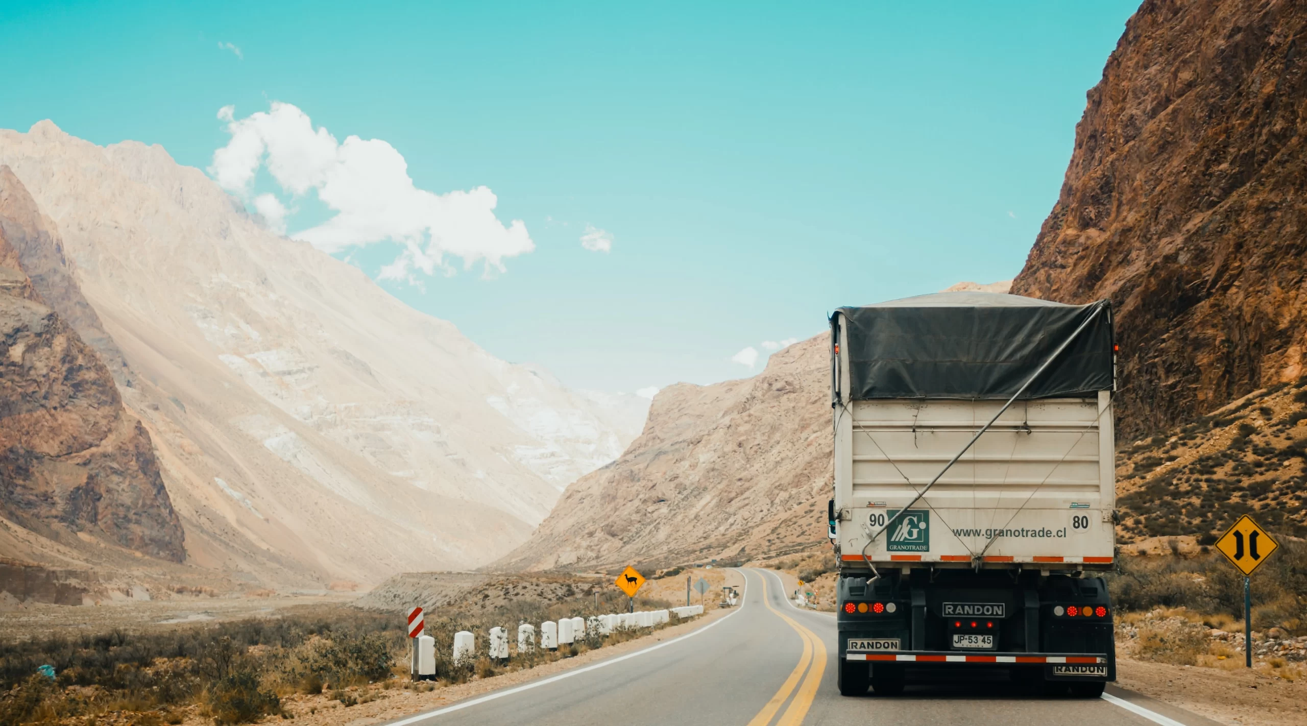 A road freight truck traversing mountainous terrain.