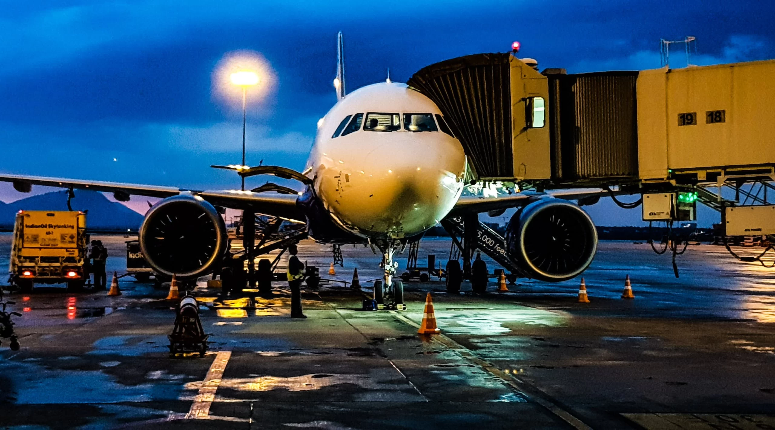 An international cargo plane is parked on the tarmac at night.
