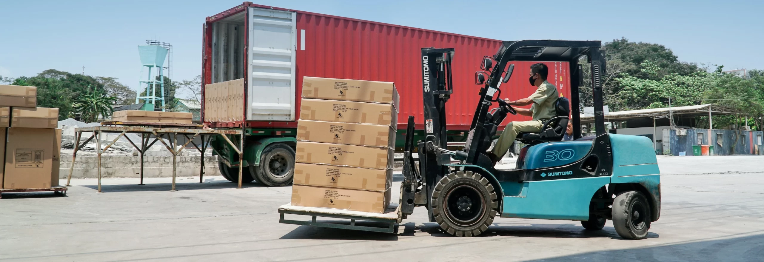 A forklift truck is transporting cargo in a warehouse.